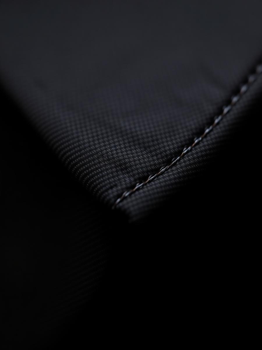 Hand finished stitching along a suit lapel